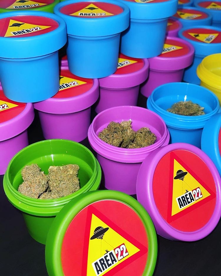 containers filled with cannabis flower and Area 22 labels