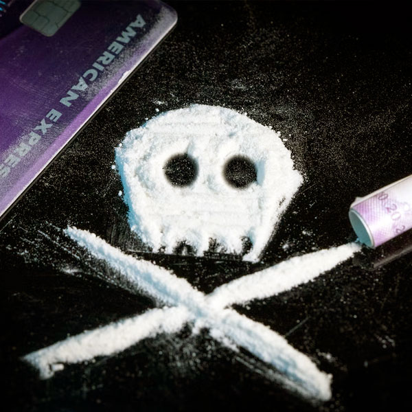 White powder on table in shape of skull and bones