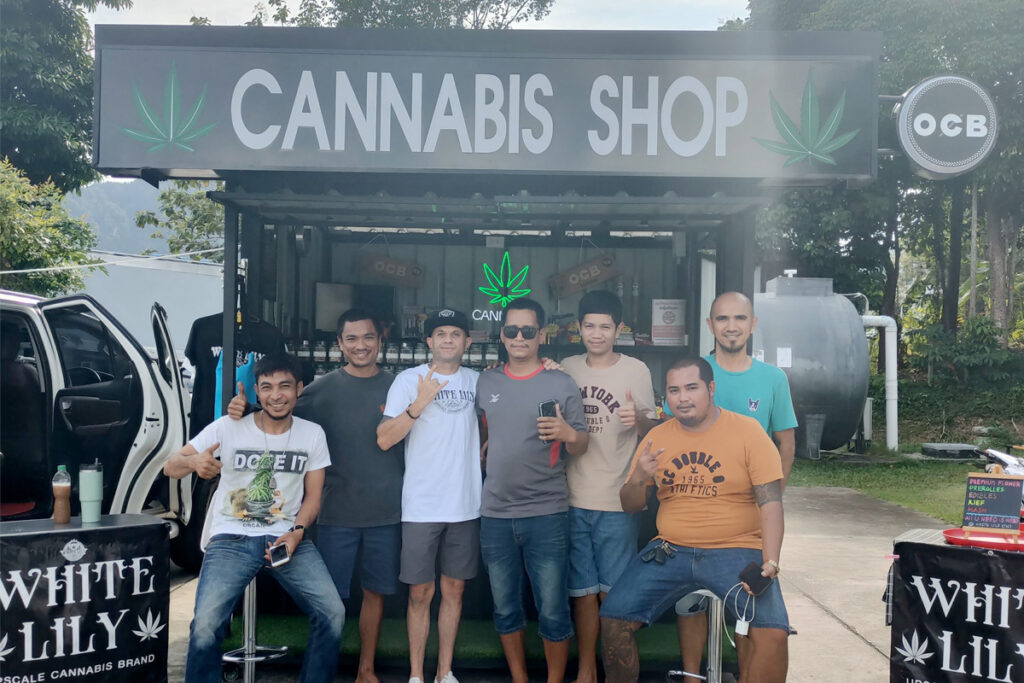 People standing in front of a cannabis store in Krabi