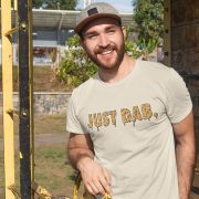 just-dab Happy man outside in the sun, wearing a tan t-shirt with the slogan "Just Dab" in a goopy sticky style.