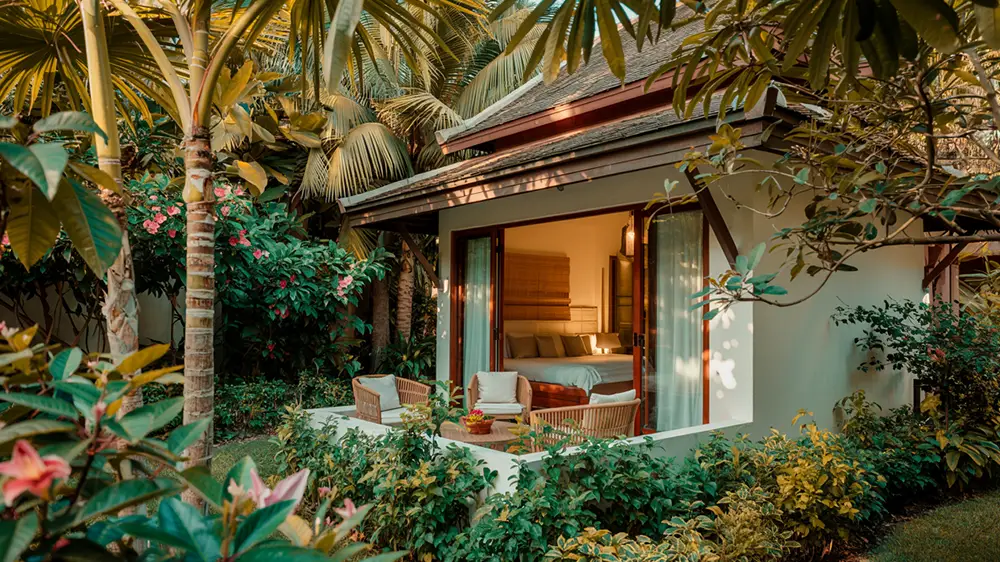 Private Thai villa surrounded by tropical garden, offering a secluded outdoor space ideal for safe cannabis use.