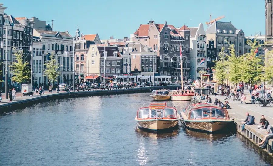 Amsterdam canal with boats and historic buildings for a cannabis travel guide